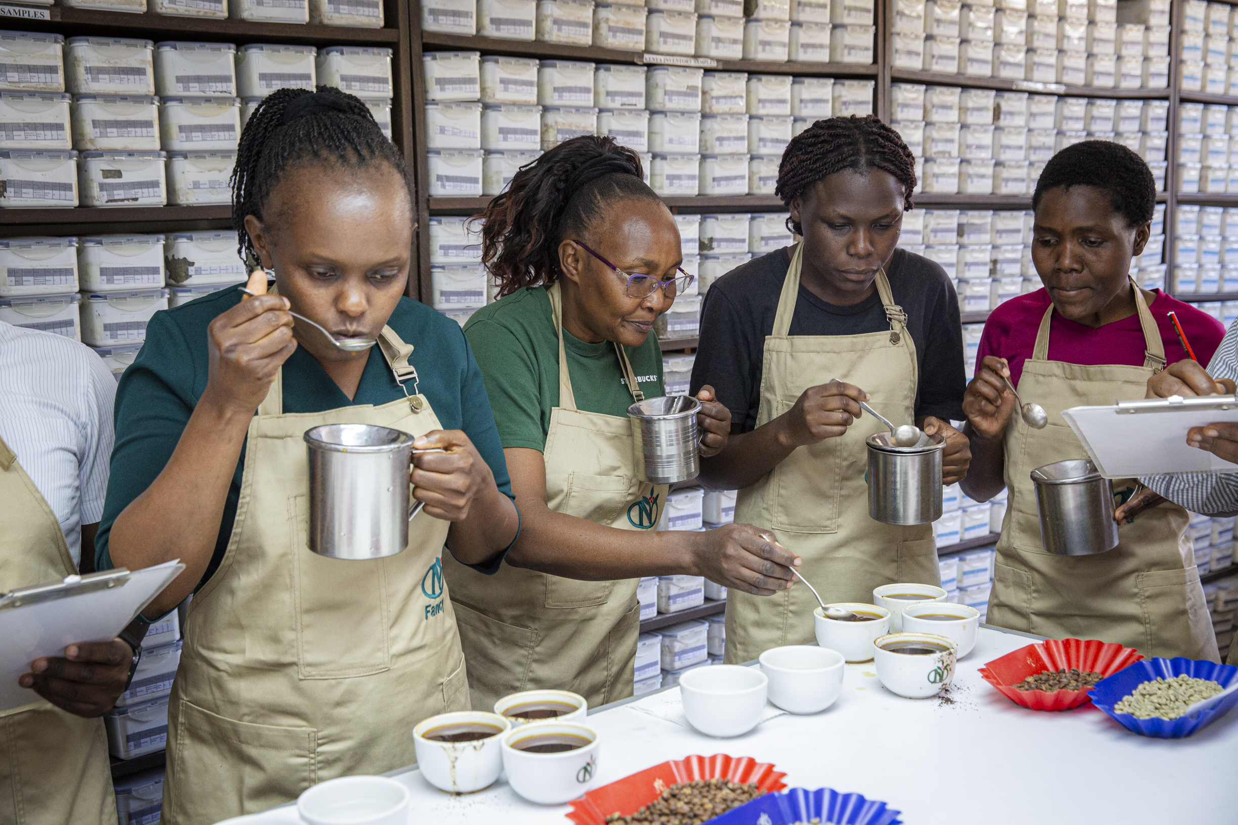 Four QC team members cupping coffee