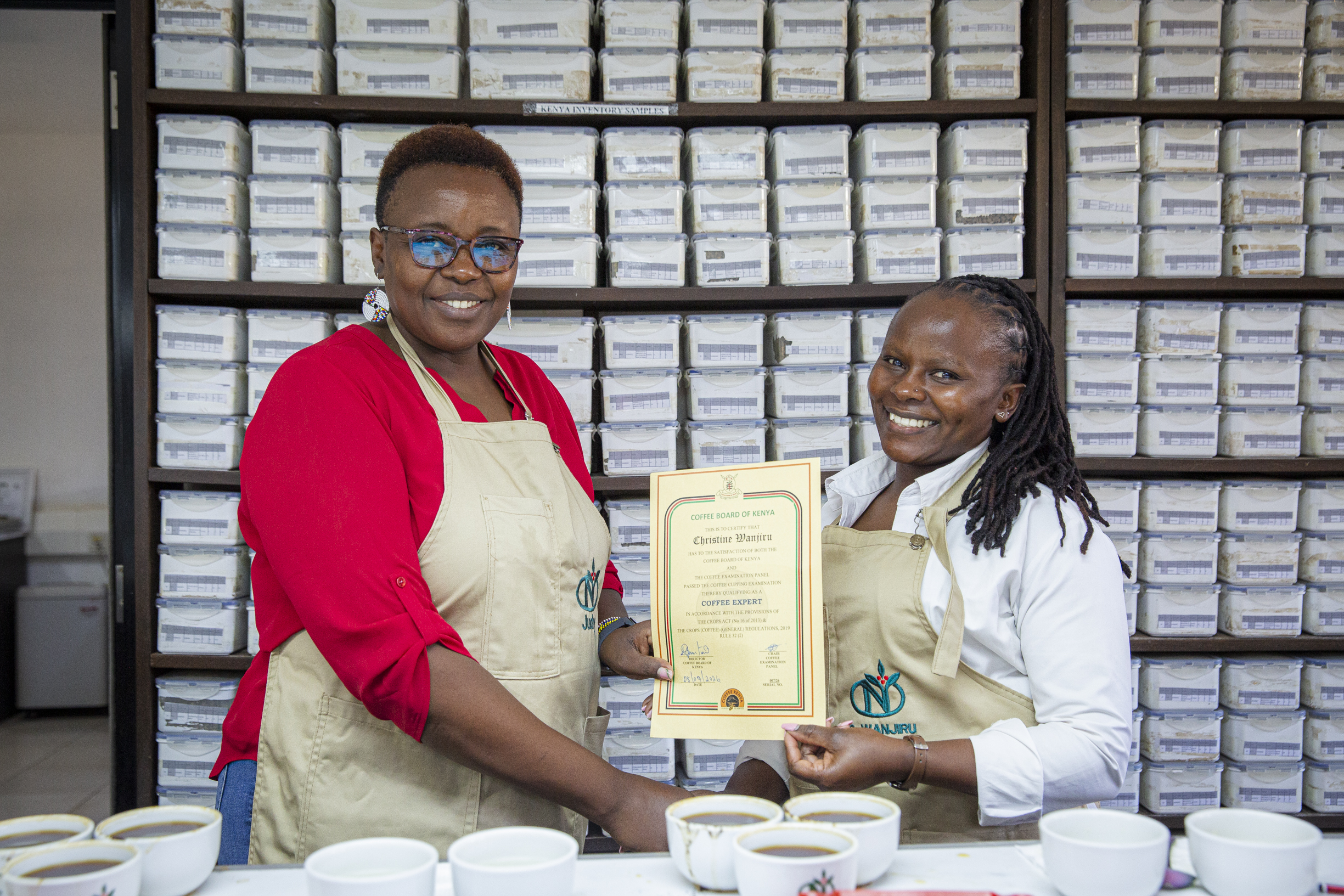 Judith Murimi presenting a certificate to a team member